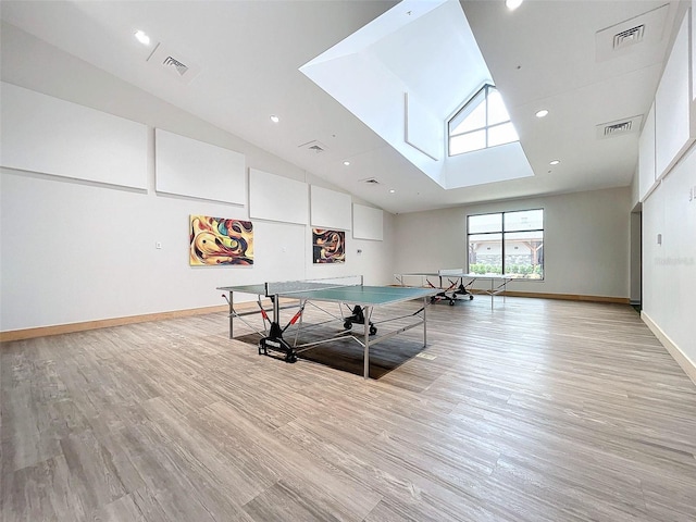 playroom with light hardwood / wood-style flooring and high vaulted ceiling