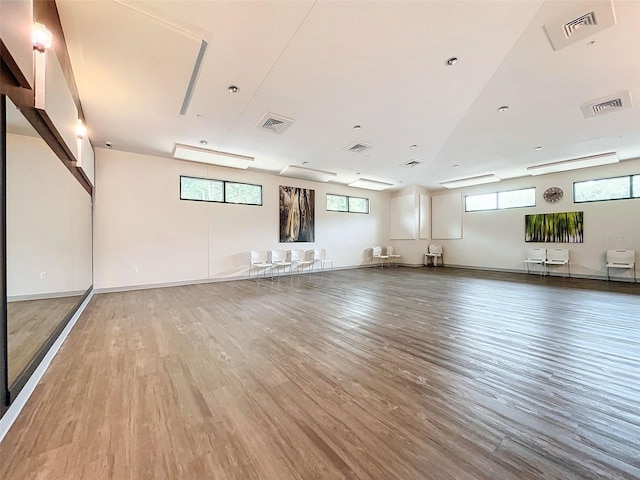 interior space with a healthy amount of sunlight and hardwood / wood-style flooring