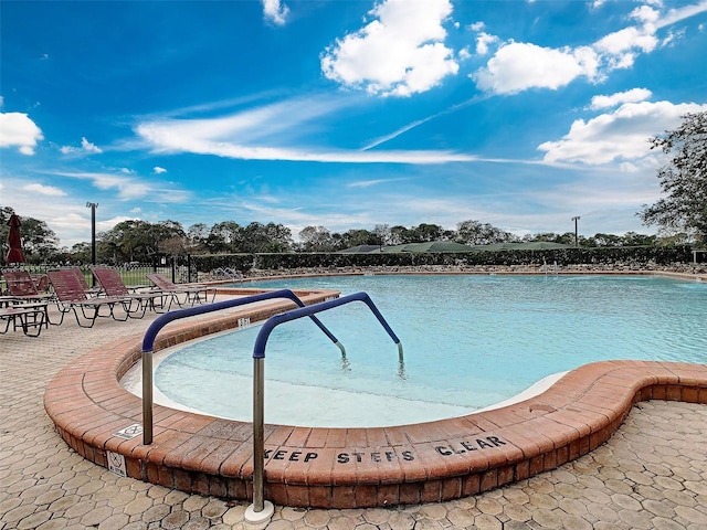 view of swimming pool with a patio area