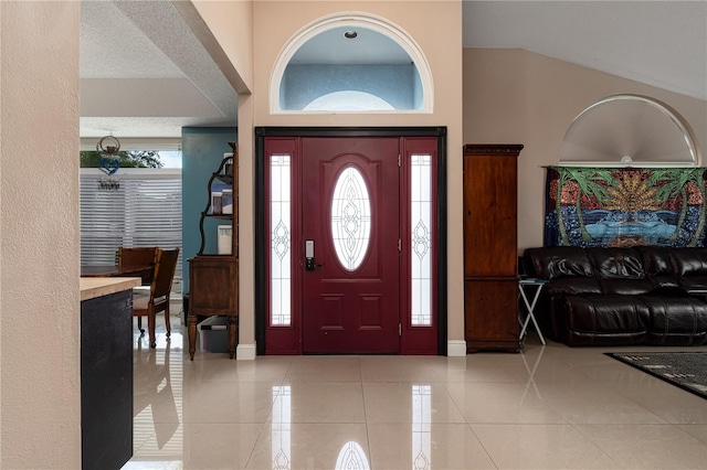 tiled foyer entrance with a textured ceiling and a wealth of natural light