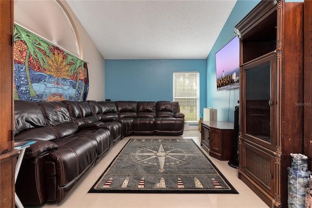 living room with vaulted ceiling, light tile patterned floors, and a textured ceiling