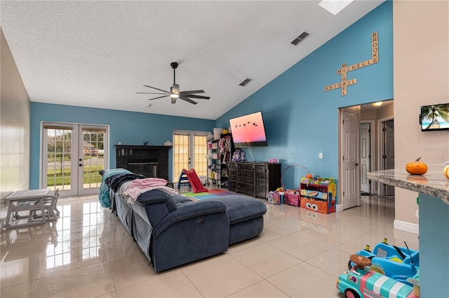 tiled living room with ceiling fan, french doors, high vaulted ceiling, and a textured ceiling