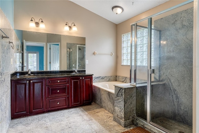 bathroom with vanity and independent shower and bath