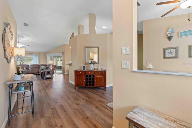 hallway featuring dark hardwood / wood-style flooring and lofted ceiling