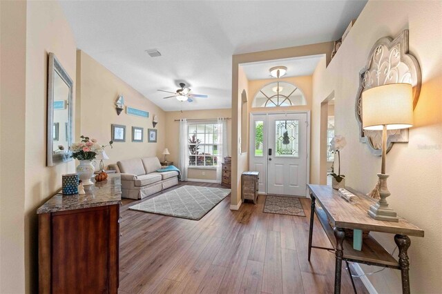 entryway with hardwood / wood-style flooring, ceiling fan, and lofted ceiling