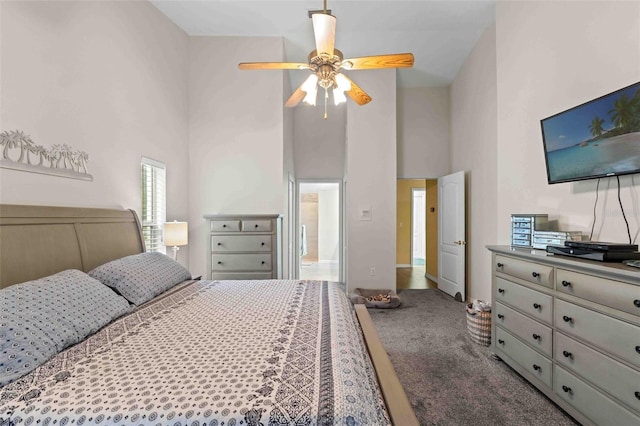 carpeted bedroom with a high ceiling and ceiling fan