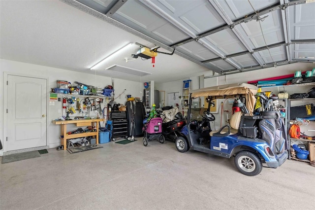 garage with a workshop area and a garage door opener