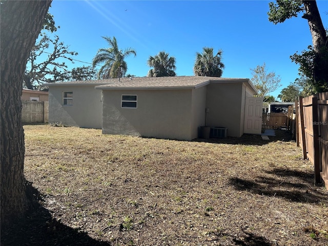 rear view of property with central AC unit