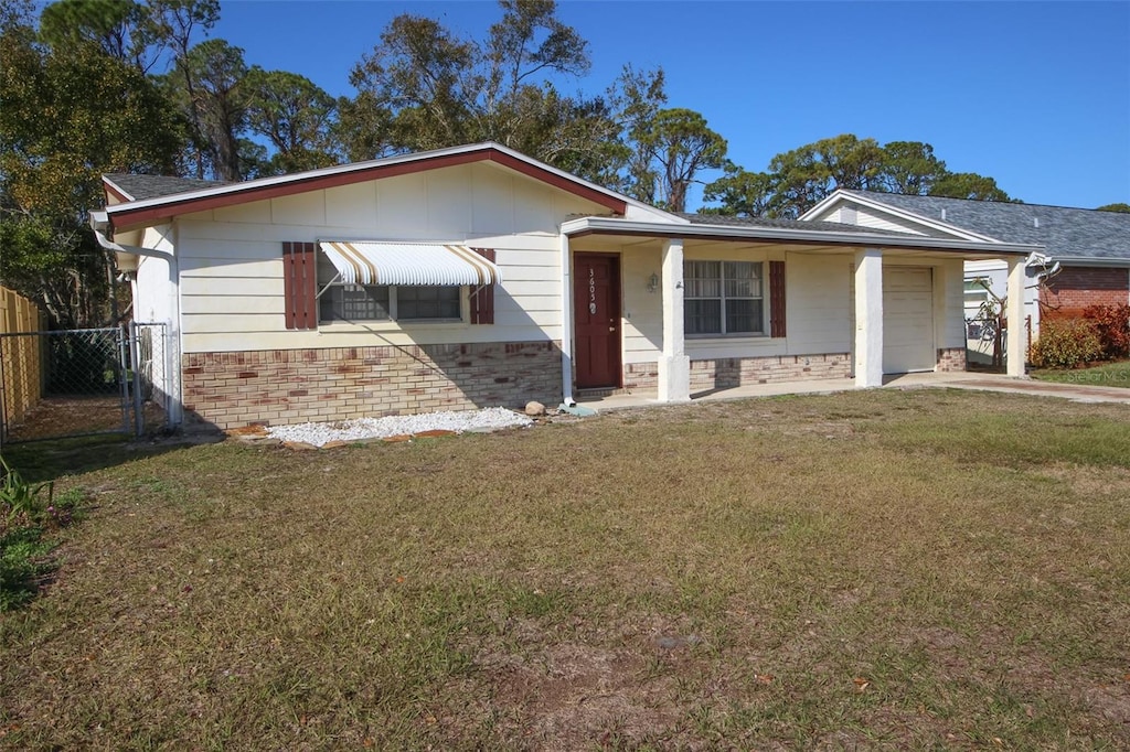 single story home with a garage, a front lawn, and a carport