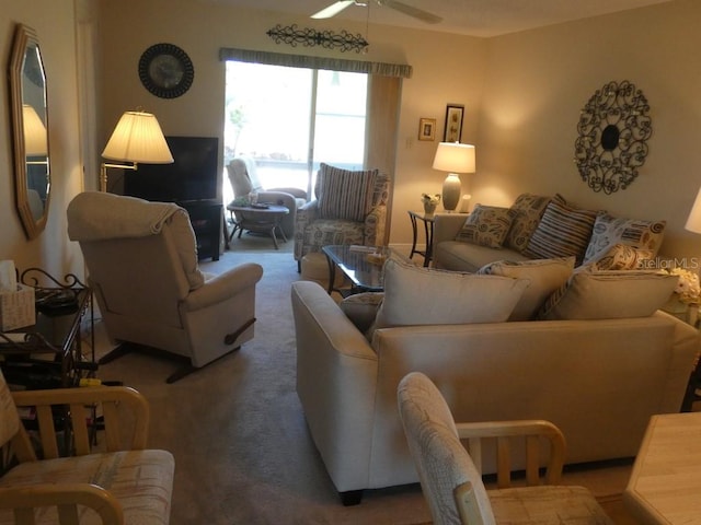 carpeted living room featuring ceiling fan