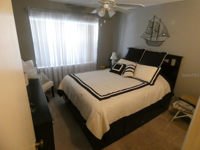 carpeted bedroom featuring ceiling fan