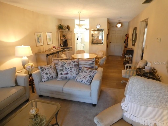 living room with a chandelier and hardwood / wood-style floors