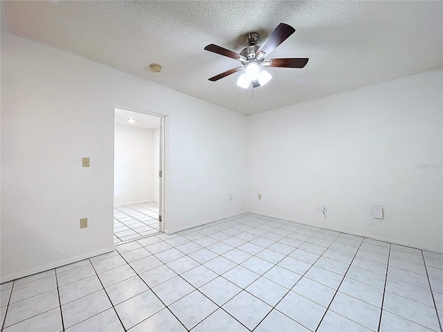 tiled empty room featuring a textured ceiling and ceiling fan