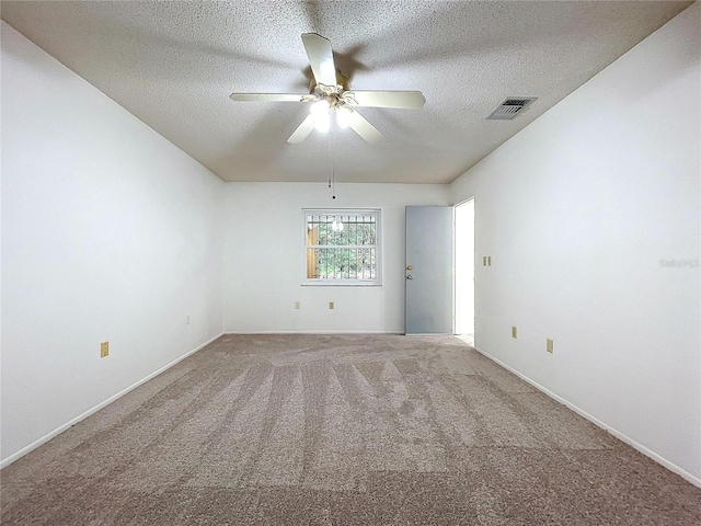 carpeted spare room featuring ceiling fan and a textured ceiling