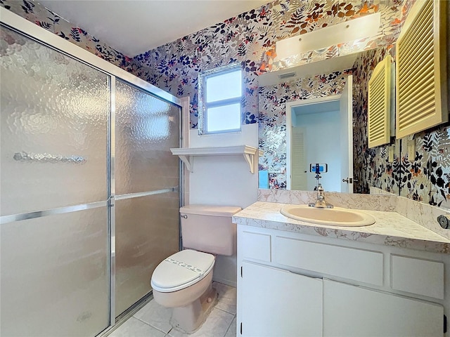 bathroom with tile patterned flooring, vanity, toilet, and an enclosed shower