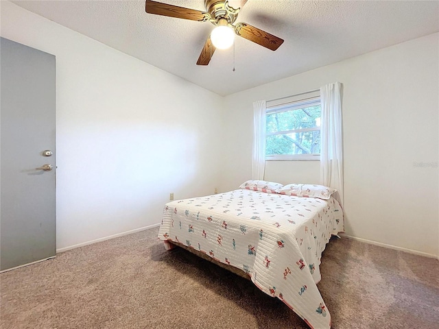 bedroom with a textured ceiling, carpet floors, and ceiling fan