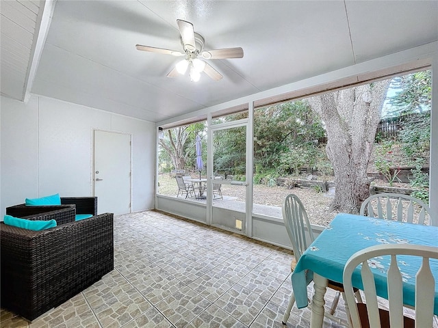 sunroom / solarium featuring ceiling fan