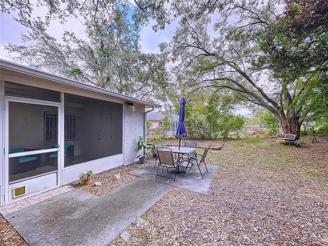 view of patio featuring a sunroom