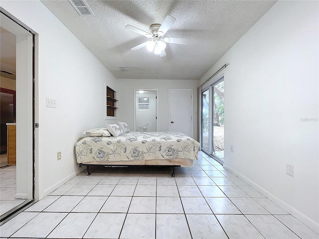 unfurnished bedroom featuring access to outside, ceiling fan, light tile patterned flooring, and a textured ceiling