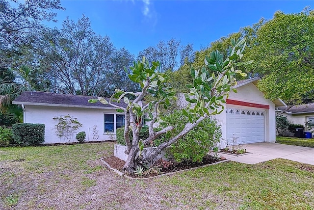 view of front of property featuring a garage and a front yard