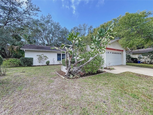 ranch-style house with a garage and a front lawn