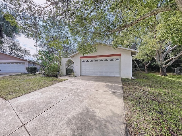 ranch-style house featuring a garage and a front yard