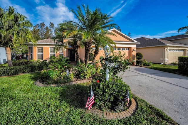 view of front of home with a front yard and a garage