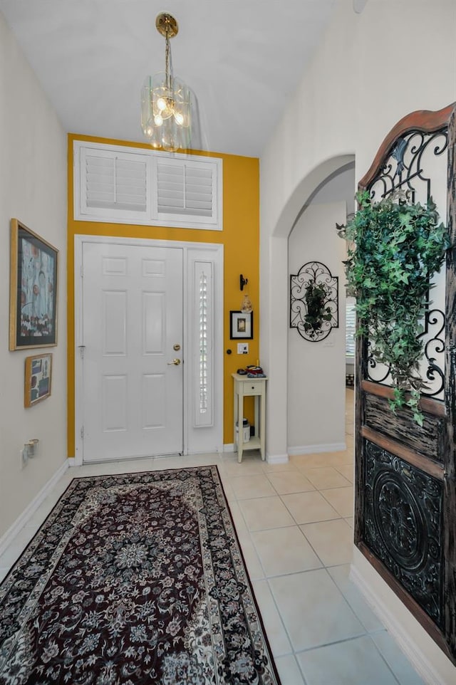 foyer entrance featuring a notable chandelier and light tile patterned flooring