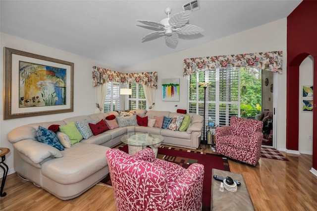 living room with hardwood / wood-style flooring, ceiling fan, and lofted ceiling