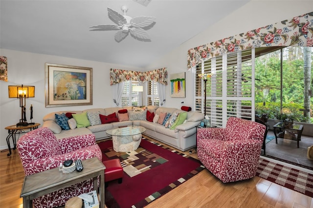 living room with ceiling fan, lofted ceiling, and hardwood / wood-style flooring