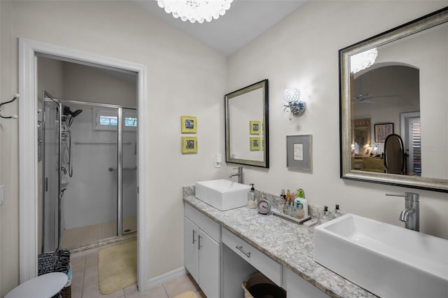 bathroom featuring tile patterned flooring, vanity, a healthy amount of sunlight, and an enclosed shower