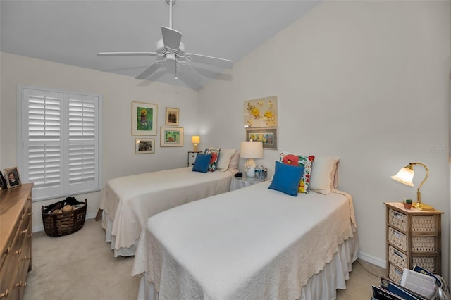 bedroom with ceiling fan, light colored carpet, and lofted ceiling