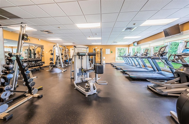 workout area with a paneled ceiling