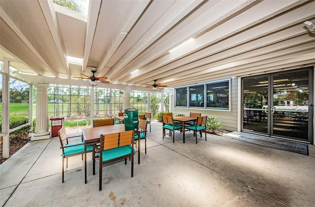 sunroom / solarium featuring ceiling fan