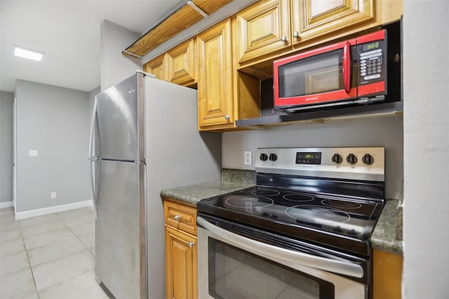 kitchen featuring light tile patterned floors and stainless steel appliances