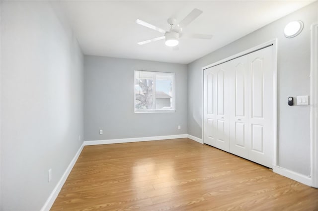 unfurnished bedroom with light wood-type flooring, a closet, and ceiling fan