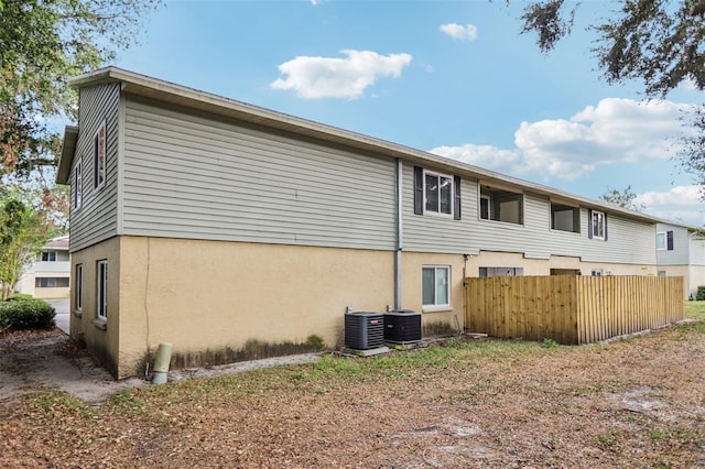 rear view of property with central air condition unit