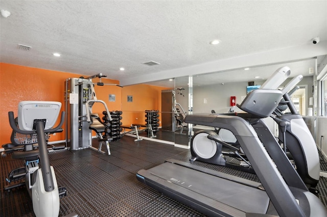 workout area with a textured ceiling