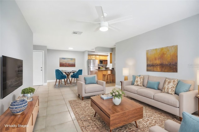 tiled living room with ceiling fan