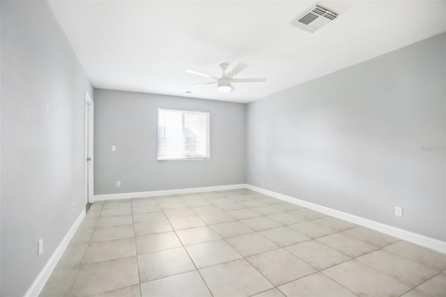 tiled empty room featuring ceiling fan