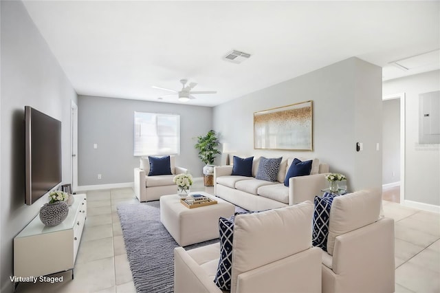 living room with electric panel, ceiling fan, and light tile patterned floors