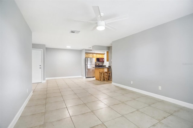 unfurnished living room with ceiling fan and light tile patterned flooring