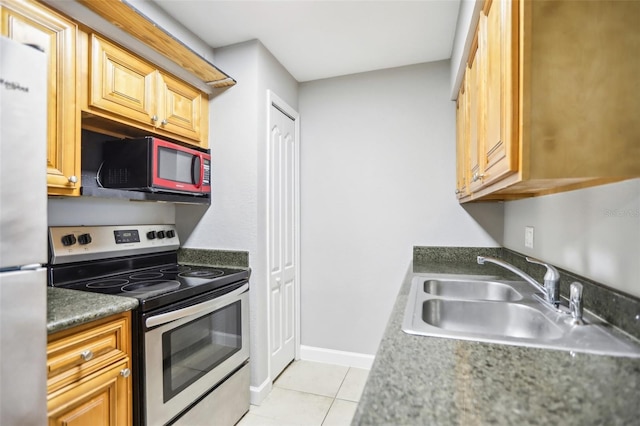 kitchen featuring light tile patterned floors, sink, and appliances with stainless steel finishes