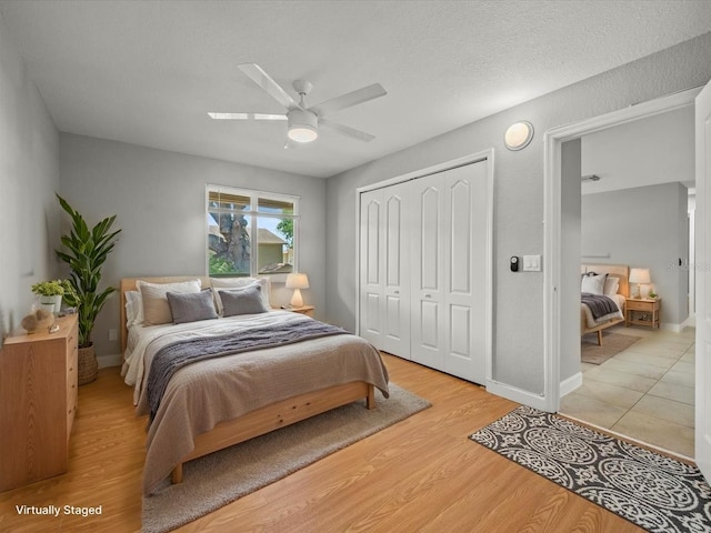 bedroom featuring a closet, ceiling fan, baseboards, and light wood-type flooring