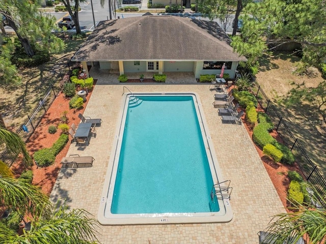 community pool featuring a patio and fence