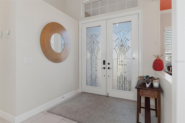 entrance foyer featuring light tile patterned floors and french doors