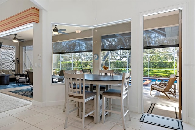 tiled dining space featuring a wealth of natural light and ceiling fan