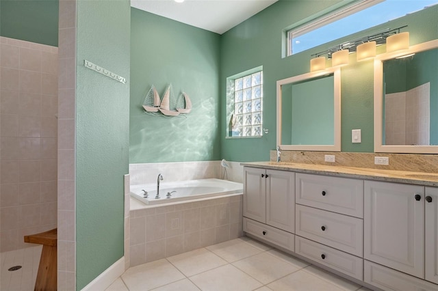 bathroom featuring tile patterned flooring, shower with separate bathtub, and vanity