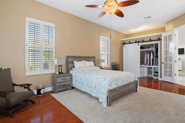 bedroom with wood-type flooring, a closet, and ceiling fan