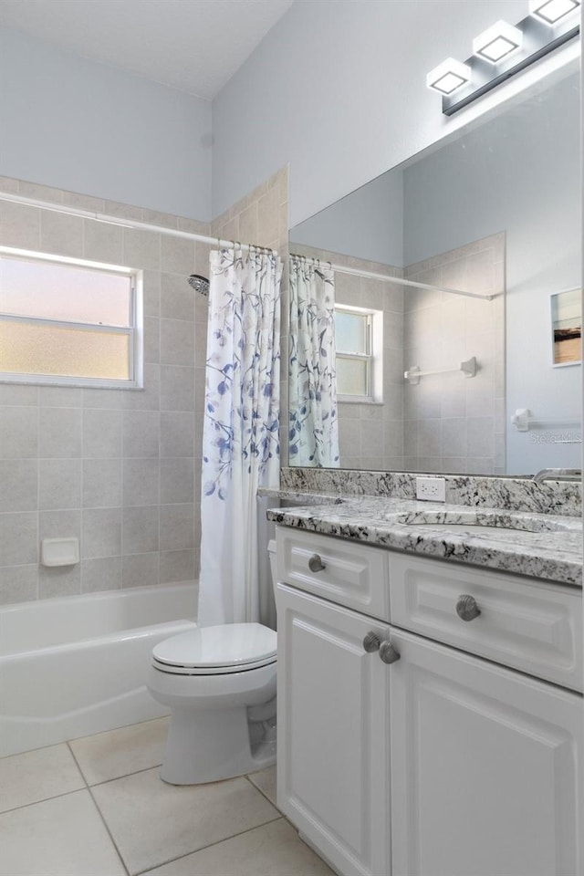 full bathroom featuring toilet, tile patterned flooring, vanity, and shower / tub combo with curtain